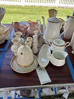 Group shot of all bone-china tea service items inside blue-taped area
