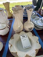 Group shot of Lenox vases, ruffled bowl and surrounding plates