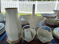 Lenox ivory porcelain vase, basket urn and two bonbon dishes grouped on table