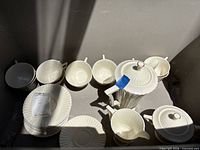 Group shot of all Rutledge pieces in bin showing teapot, sugar, creamer, cups, saucers