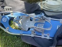 Close view of blue snowshoe showing bindings and bag
