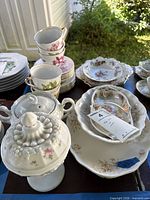 Group view of teacups, saucers, covered compote, divided dish and platter