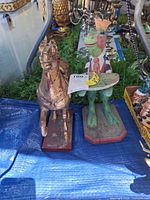 Horse and frog statues side by side showing scale and bases