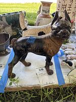 Dark brown-black cast iron terrier door stop standing on table