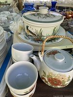 Overall lot showing cups, teapot, covered dish, underplate and tray