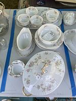 Full lot overview showing tureen, gravy boat, bowls, cups, saucers, plates