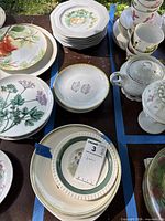 Stack of Bunnykins plates within taped lot area