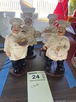 Front view of all four chef figurines standing on bases