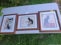 All three framed prints on table