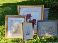All four framed artworks grouped outdoors