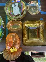 Overhead view showing iridescent round bowl, etched compote lid, oval divided dish, square ribbed bowl and bird covered dish