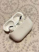 Open charging case with both AirPods Pro earbuds visible