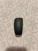 Rear view of Audi key fob displaying Audi rings logo