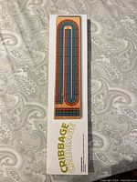 front of sealed cribbage board box showing board design
