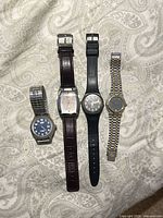 Group shot of four wristwatches side by side