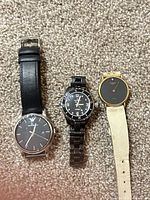 All three watches side by side on carpet