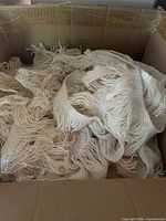 Box filled with cream nylon fringe