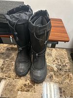 Front view showing both boots, drawstrings, toe condition