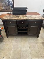 Front view showing drawers, wine rack, cabinets
