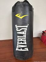 Front view of Everlast black punching bag showing logo and overall condition