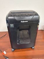 Front view of Fellowes 12C shredder showing window and casters