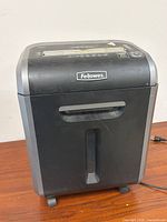 Front view showing entire Fellowes shredder on casters