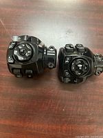 Left and right black handlebar control switch housings front view