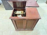 Closed console showing wood veneer cabinet and lattice front
