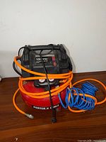 Front view of Porter-Cable air compressor with hoses