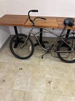 Left side view of Rossini cruiser bicycle showing frame, wheels, handlebars, and rear rack