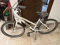 Full right-side view of white Boss Cruiser step-through bicycle showing Jamis fork and 26-inch wheels