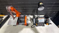 Both power tools side by side on table