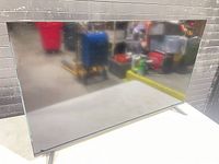 Front view of Insignia 40-inch TV on table showing screen and stand legs