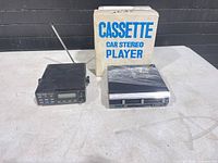 Scanner, cassette player, and box on table
