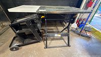 Overall view of Chicago Electric welding table and steel rolling cart