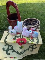 Group view of all items: four cat pillows, red wooden bucket, woven basket, floral latch hook canvas