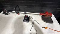 Full view of Craftsman 40V string trimmer with battery attached and charger