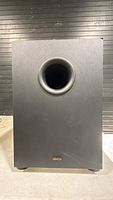 Front view of Denon DSW-76 subwoofer showing port and cabinet condition