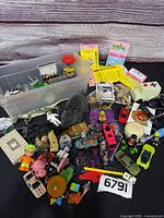 Overview of entire lot spread out with bin and toys