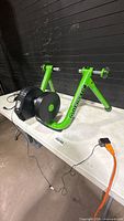 Full view of Kinetic trainer on table with power and adapter cable visible