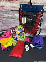 Group shot of Reebok bag, Magic Kyte box, pouch kites, string spool and loose fabric pieces