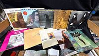 Group shot of all ten LPs on chair