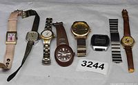 Group view of eight watches and spare band