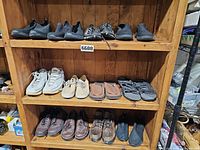Full shelving view with multiple pairs of shoes across three shelves