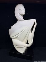 Front view of white plaster bust sculpture on black base