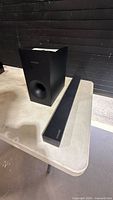 Soundbar and wireless subwoofer on table