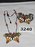 Necklace, cuff bracelet, maker tag and lot number displayed