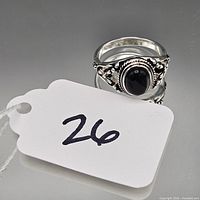 front view of sterling silver ring showing onyx stone and filigree detail