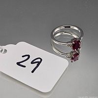 Ring showing band, prong setting and red stone with lot tag 29