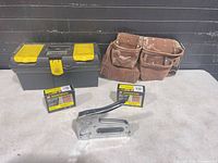 Group shot of toolbox, tool belt, two screw boxes and stapler